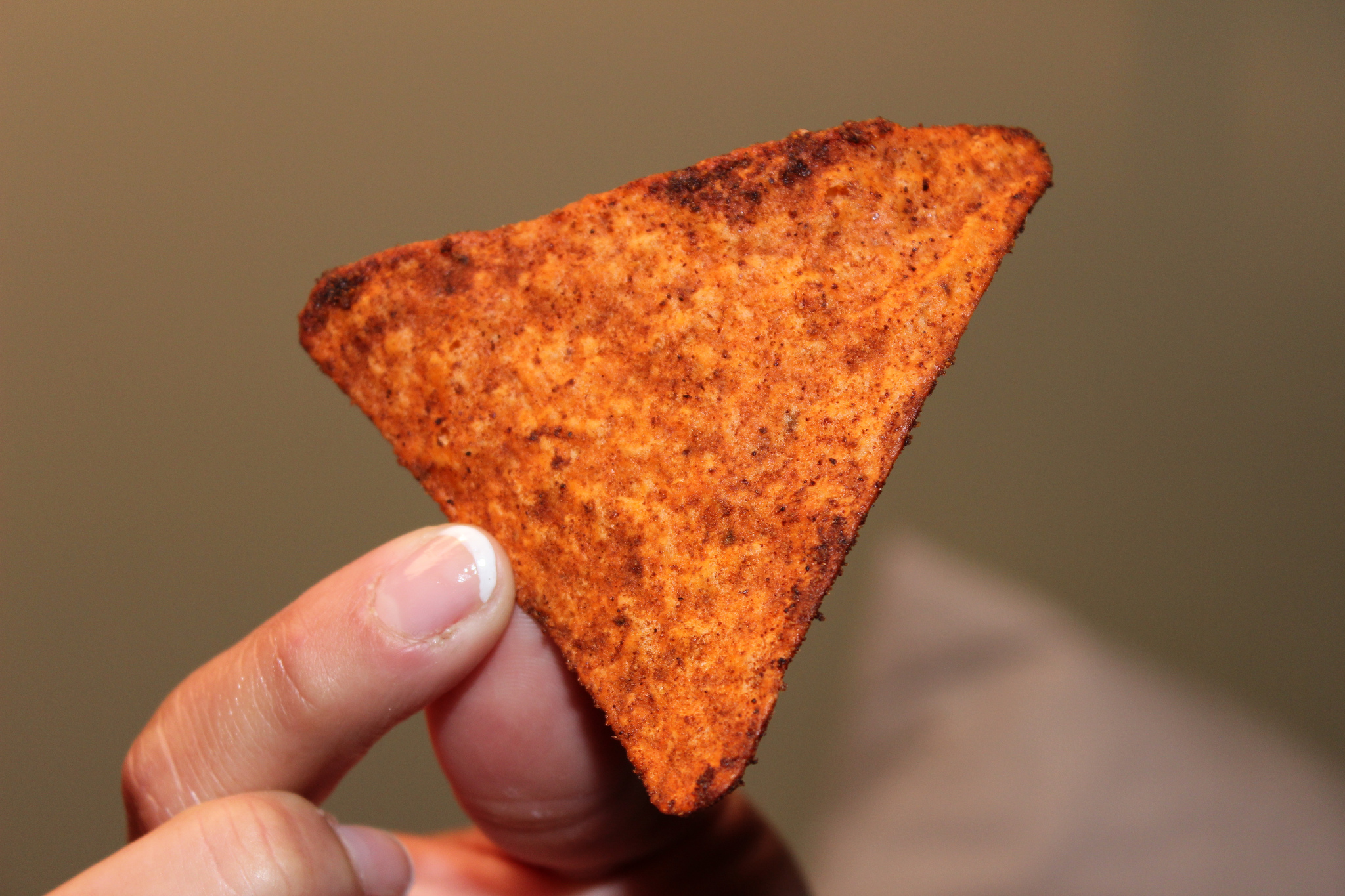 two fingers hold up on doritos chip