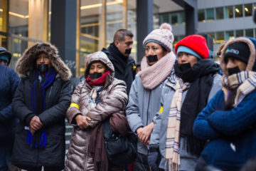 Protestors stand with their mouths taped over during the Wendy's boycott