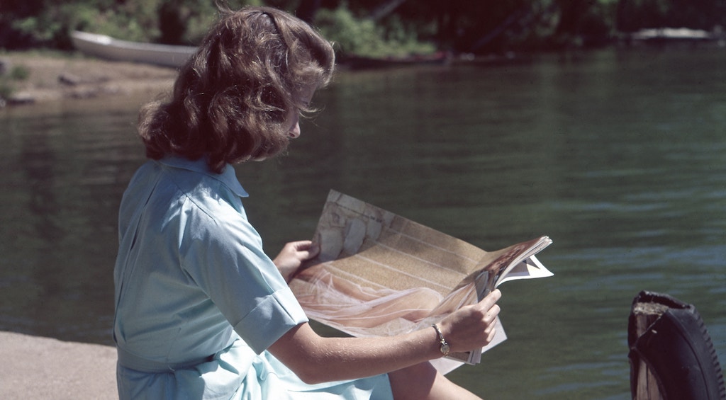woman reading on a dock