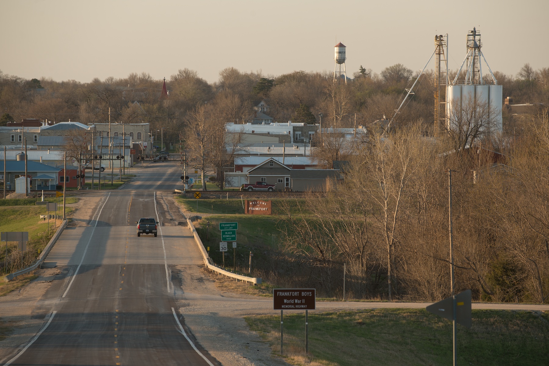 Frankfort, Kansas, looking straight down Main Street. Pictured are the main rail lines, grain elevators, old water tower, and church steeple popping up from the trees