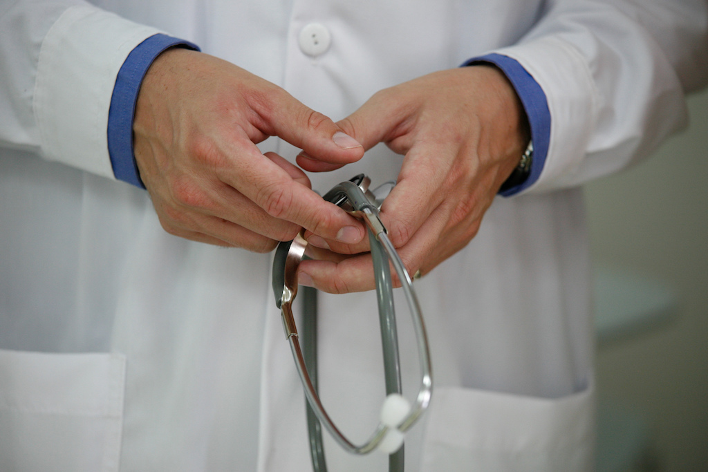 doctor holds stethoscope
