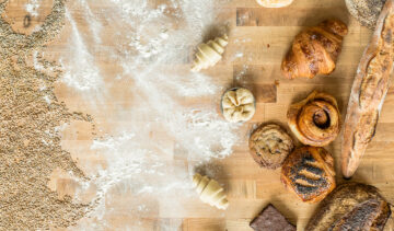 seeds, flour, and loaves of bread on a table