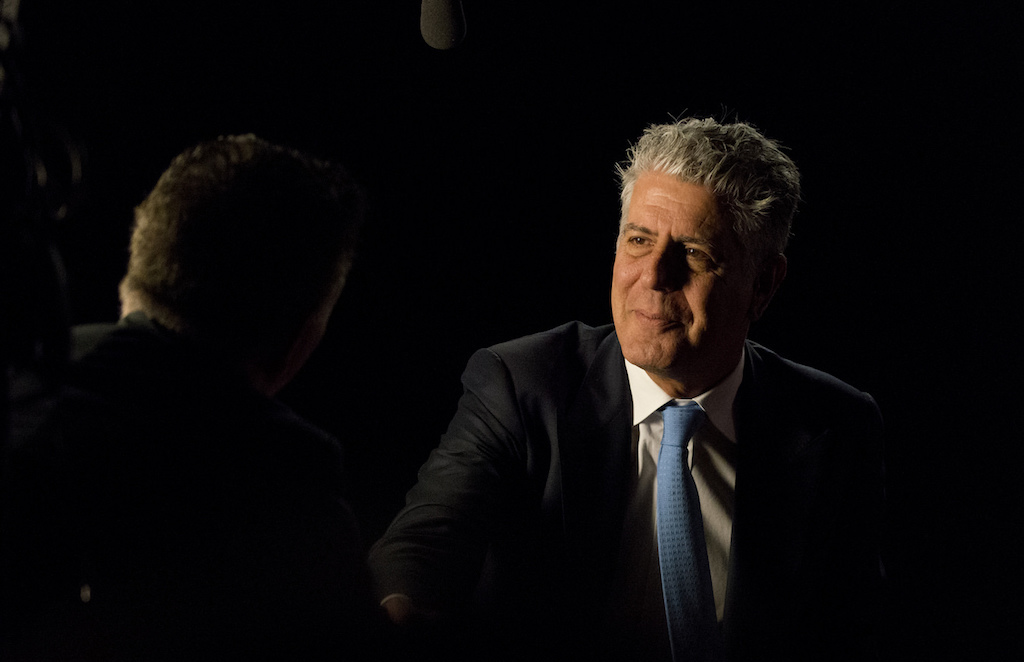 anthony bourdain with a black background