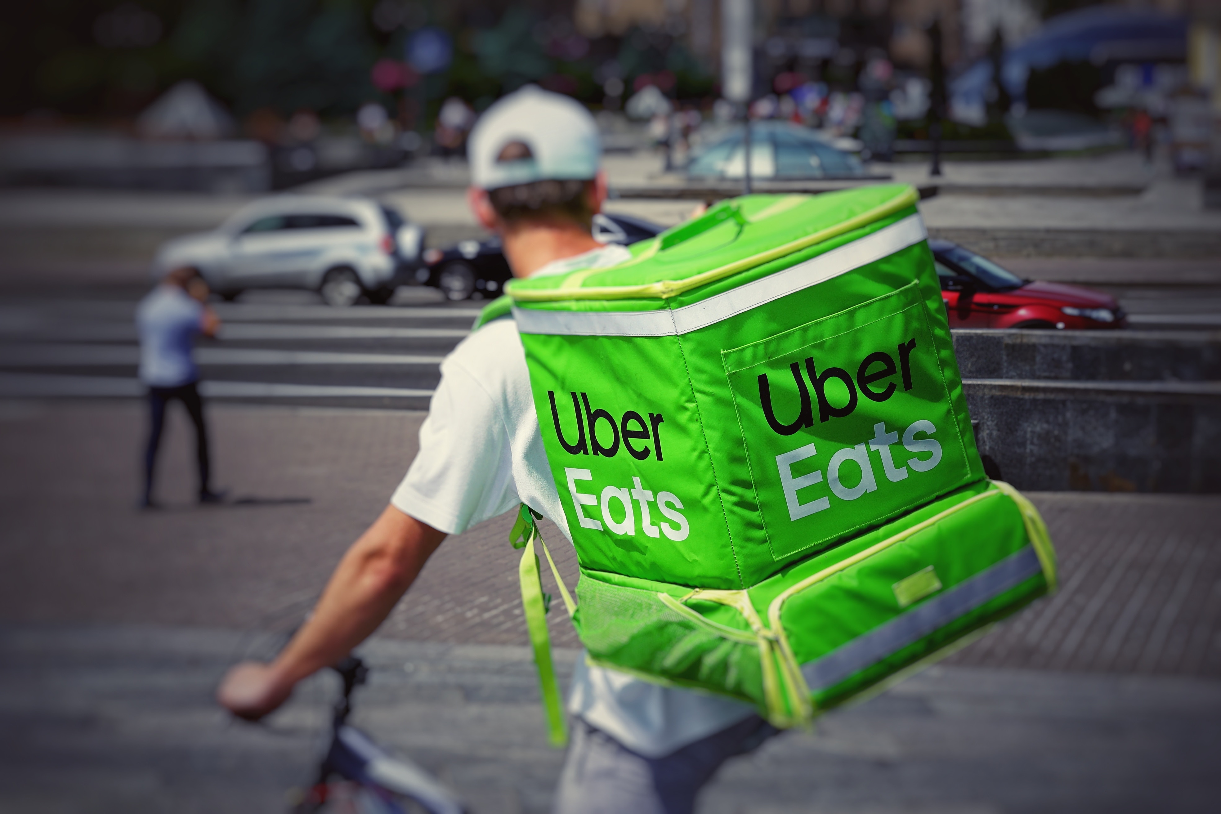 Man on a bike with an Uber Eats backpack.