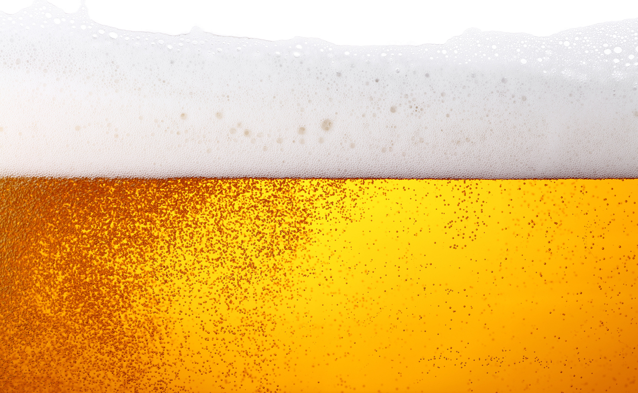 Close up background texture of lager beer with bubbles and froth in glass