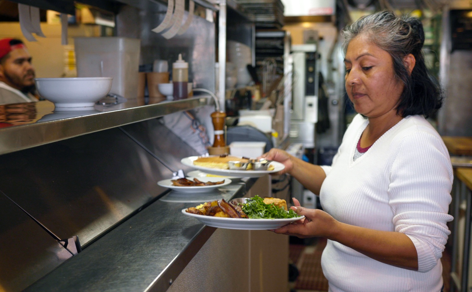 Sol serving food at Huckleberry Café, a restaurant in Santa Monica, California (March 2020)