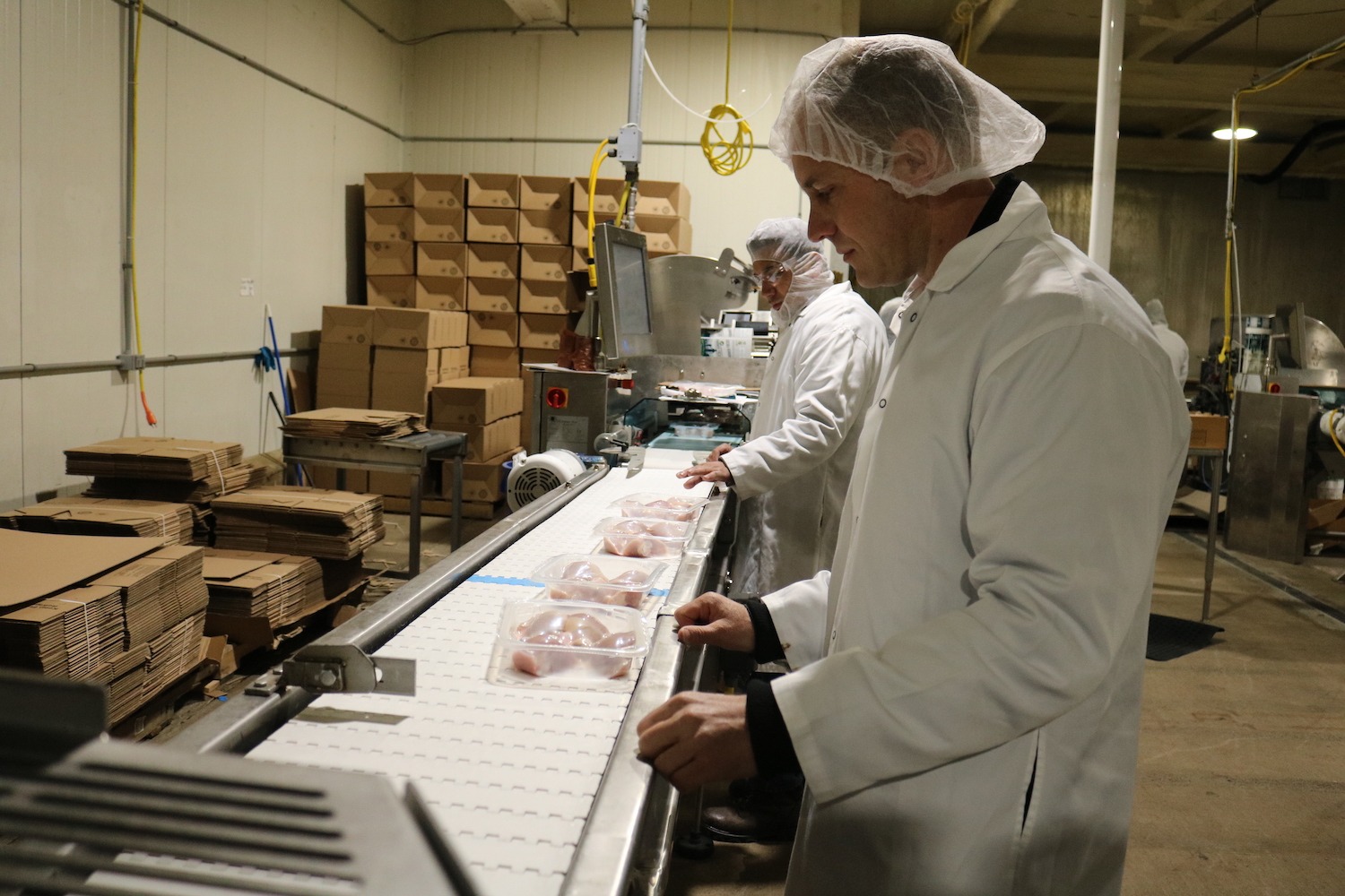 Corwin Heatwole watches drumsticks come off the packaging line at the company's processing plant in Harrisonburg, Virginia (March 2020)