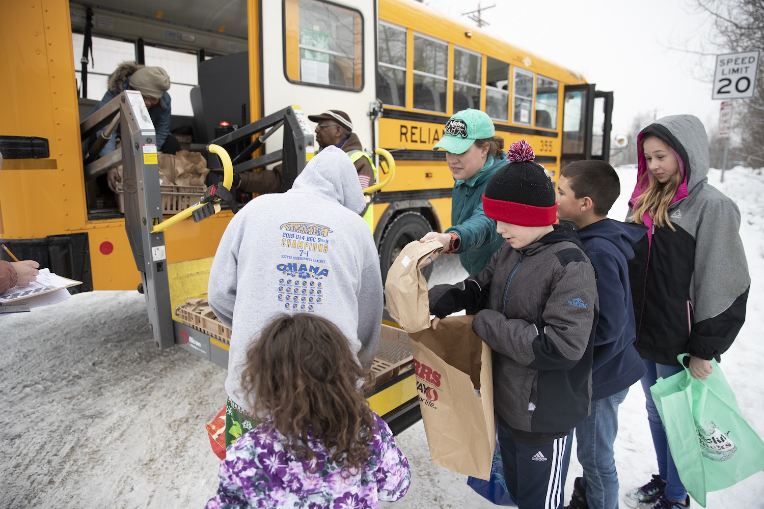 Anchorage school district students pick up food from mobile food delivery April 2020