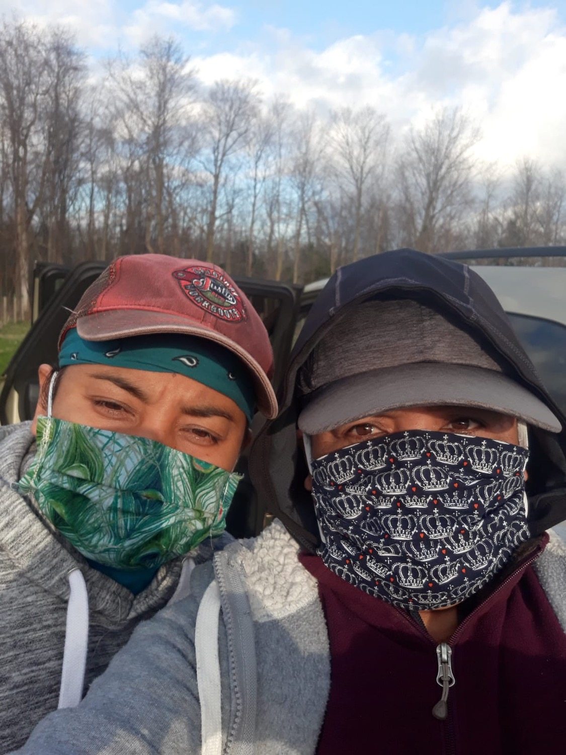 two farmworkers wearing masks selfie April 2020