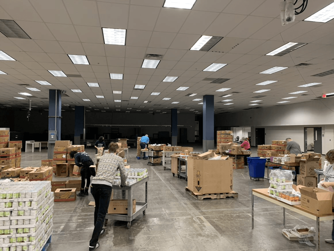 volunteers sorting food moving carts April 2020