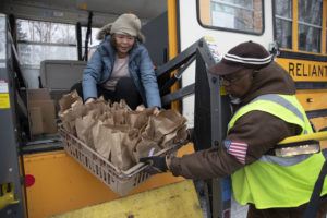 Anchorage school district employees unload food for students April 2020
