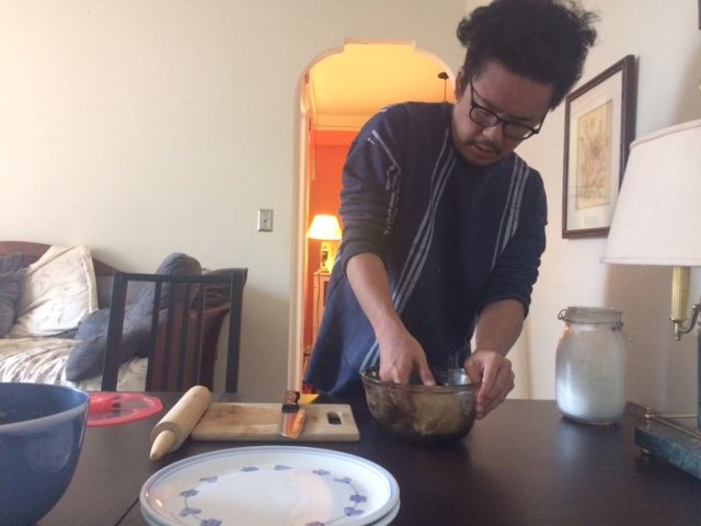 Mcarthy's partner, Dennis prepares dumplings at her kitchen table while in quarantine May 2020