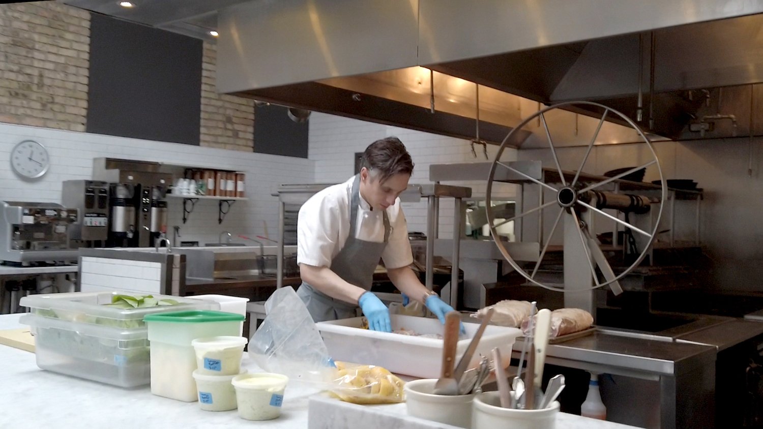 Chef handles meat with gloves at Spoon May 2020