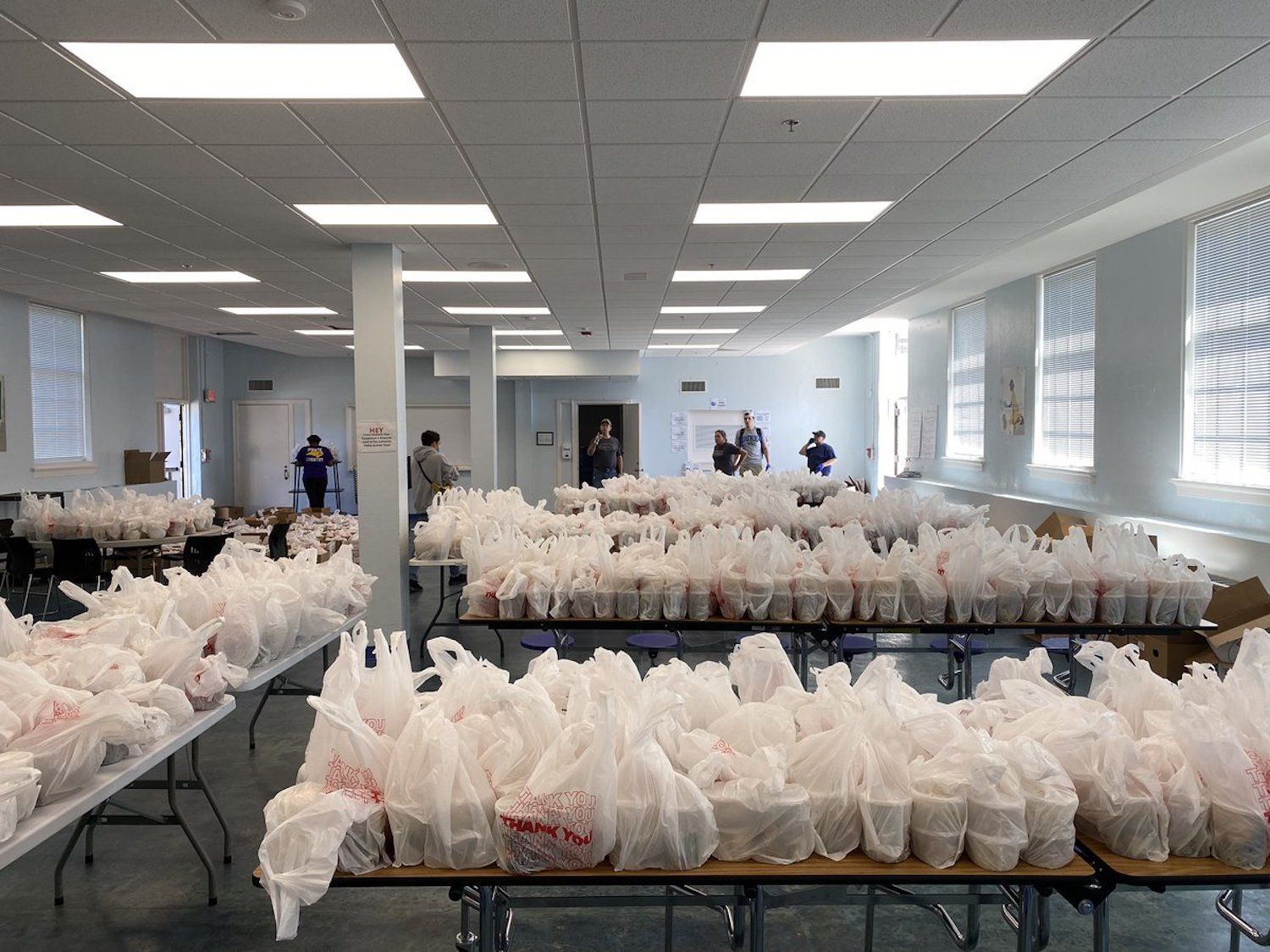 Tables filled with plastic take-out lunch bags in Durham, North Carolina.