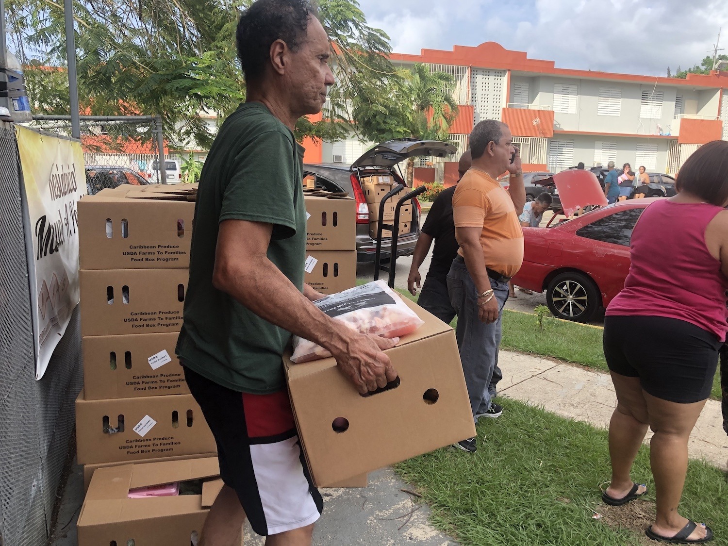 Manuel A. Perez Housing Project resident receives food box at a distribution event June 2020