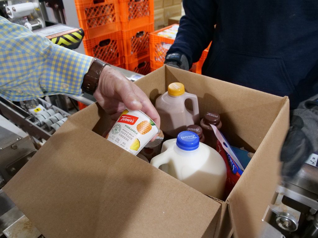 A gallon of fluid milk in a cardboard box, to be distributed to food banks as part of the USDA's farmers to families food box program.