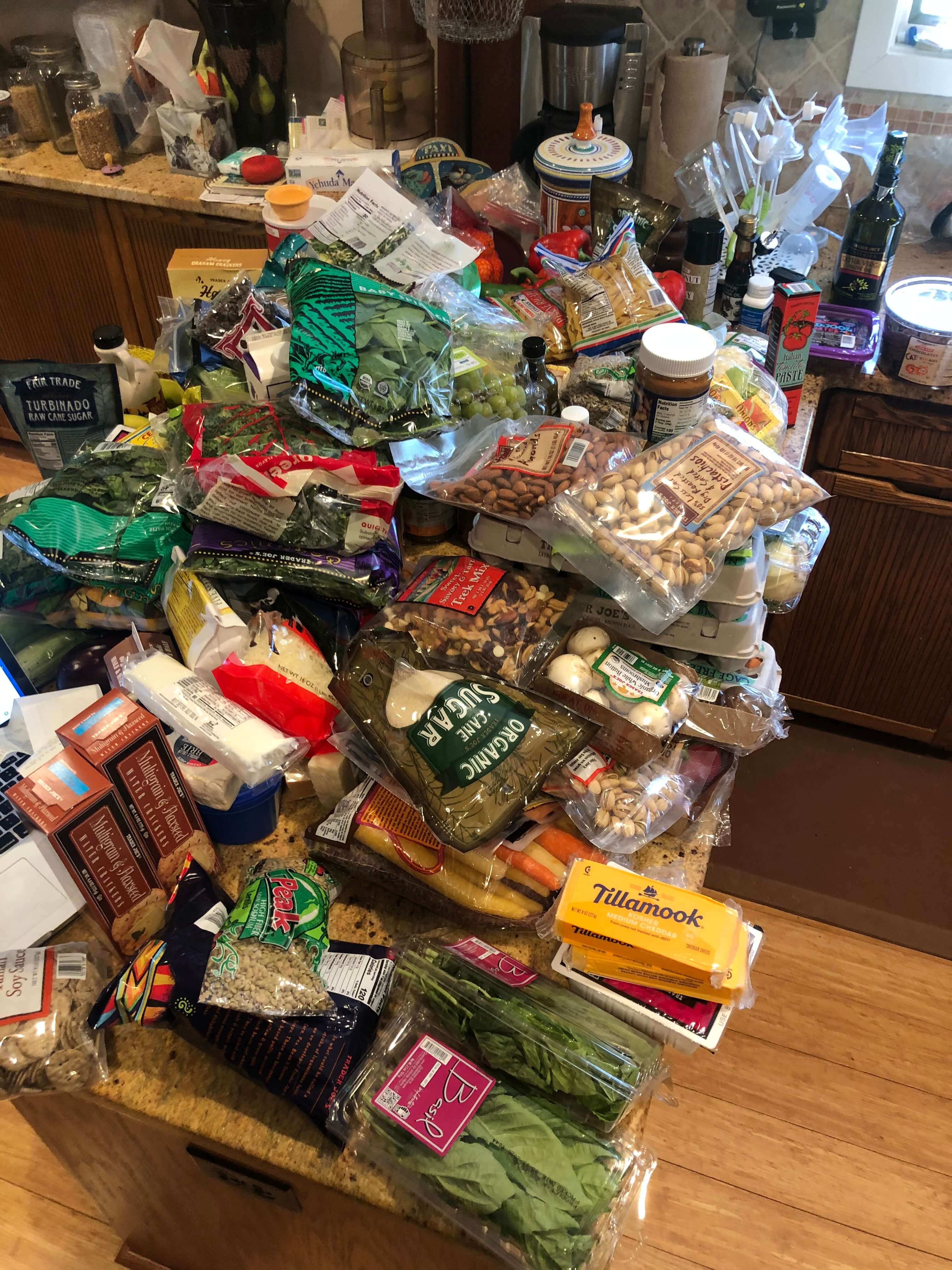 Kitchen table piled with grocery items from Trader Joe's. (June 2020)