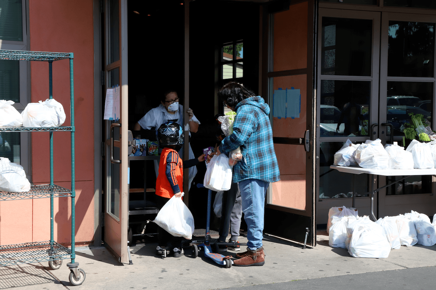 A family picks up a grab-and-go school lunch in Berkeley, California.
