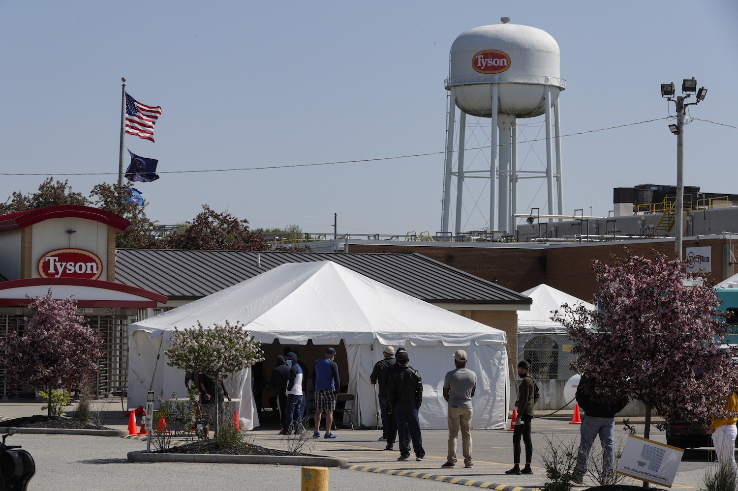 workers wait in line to enter Tysons Foods pork processing plant Logansport, Ind., Thursday, May 7, 2020