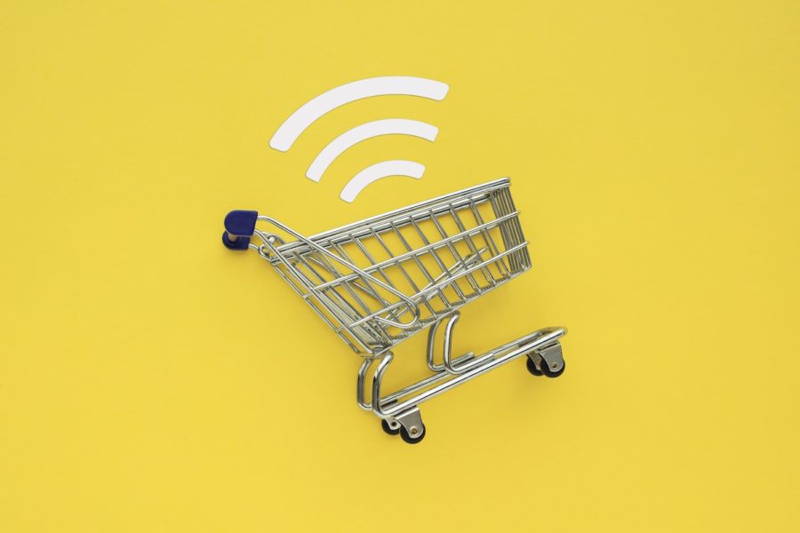 metal shopping cart with wifi symbol and yellow background July 2020