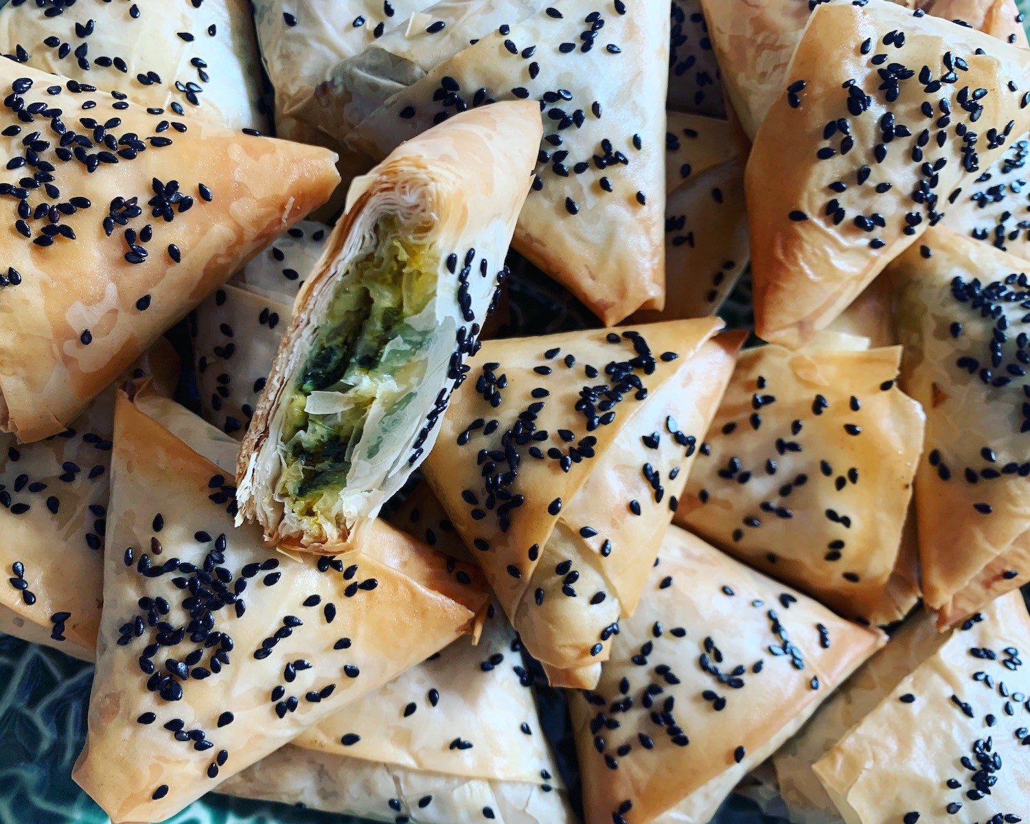 Filo dough filled with spinach and sprinkled with sesame seeds. September 2020