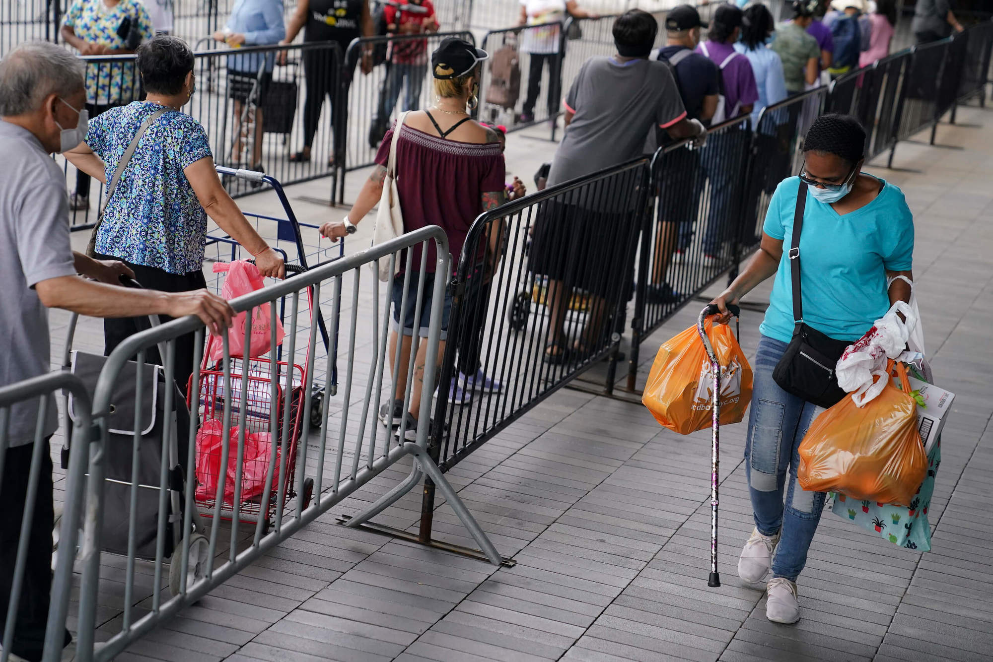 pedestrians wait in line for groceries, New York City. September 2020