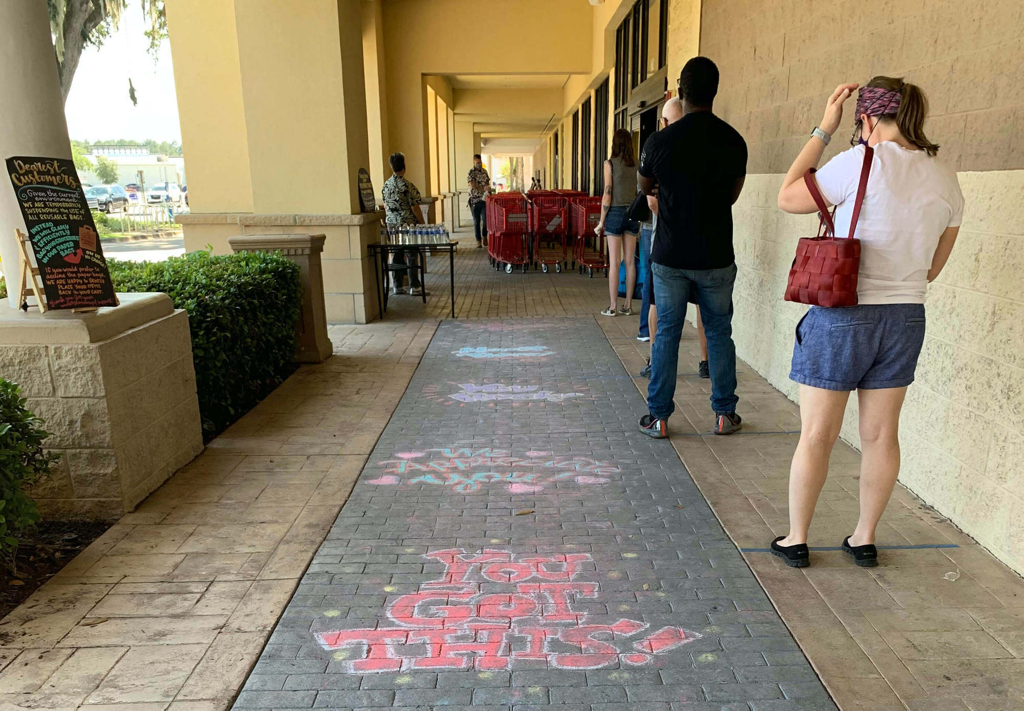 People wait in line to enter a Trader Joe's in Gainesville, Florida. September 2020