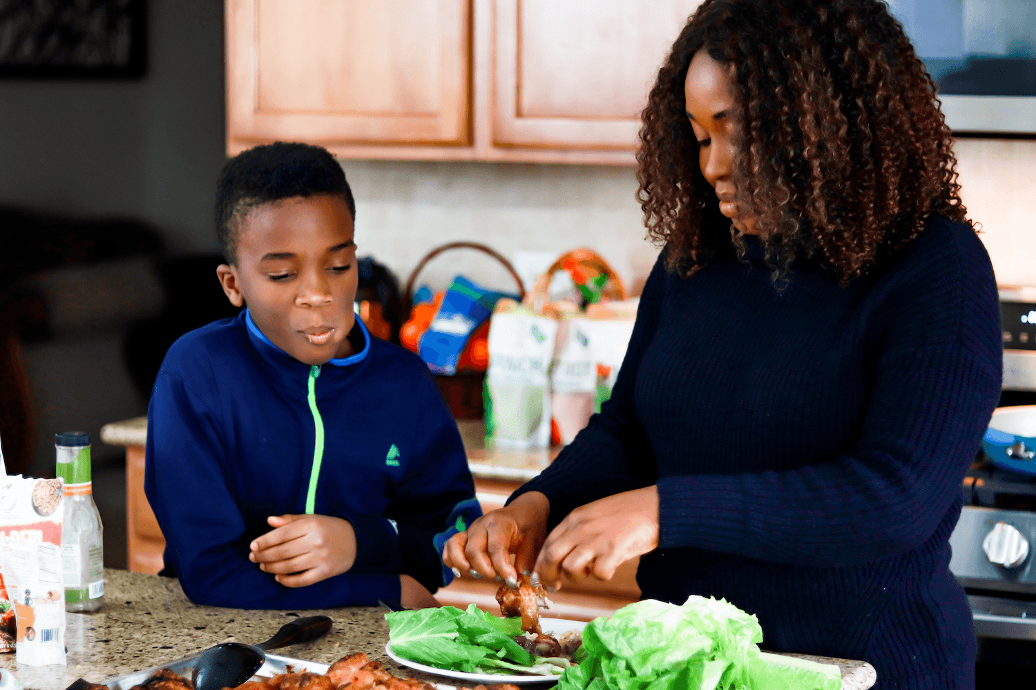 Toyin Kolawole and her son in the kitchen. October 2020