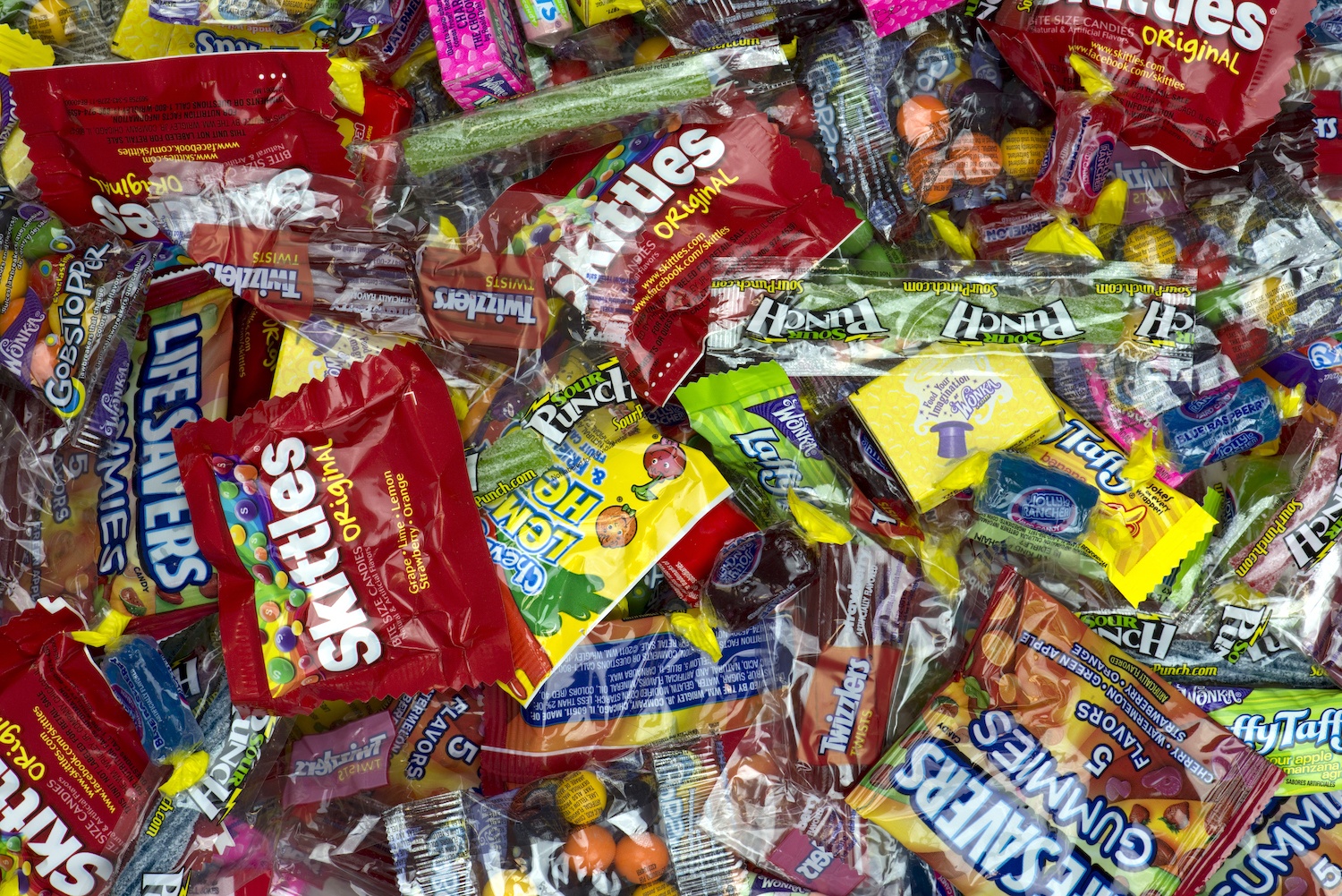 Large pile of sweet and sour candy wrappers. October 2020