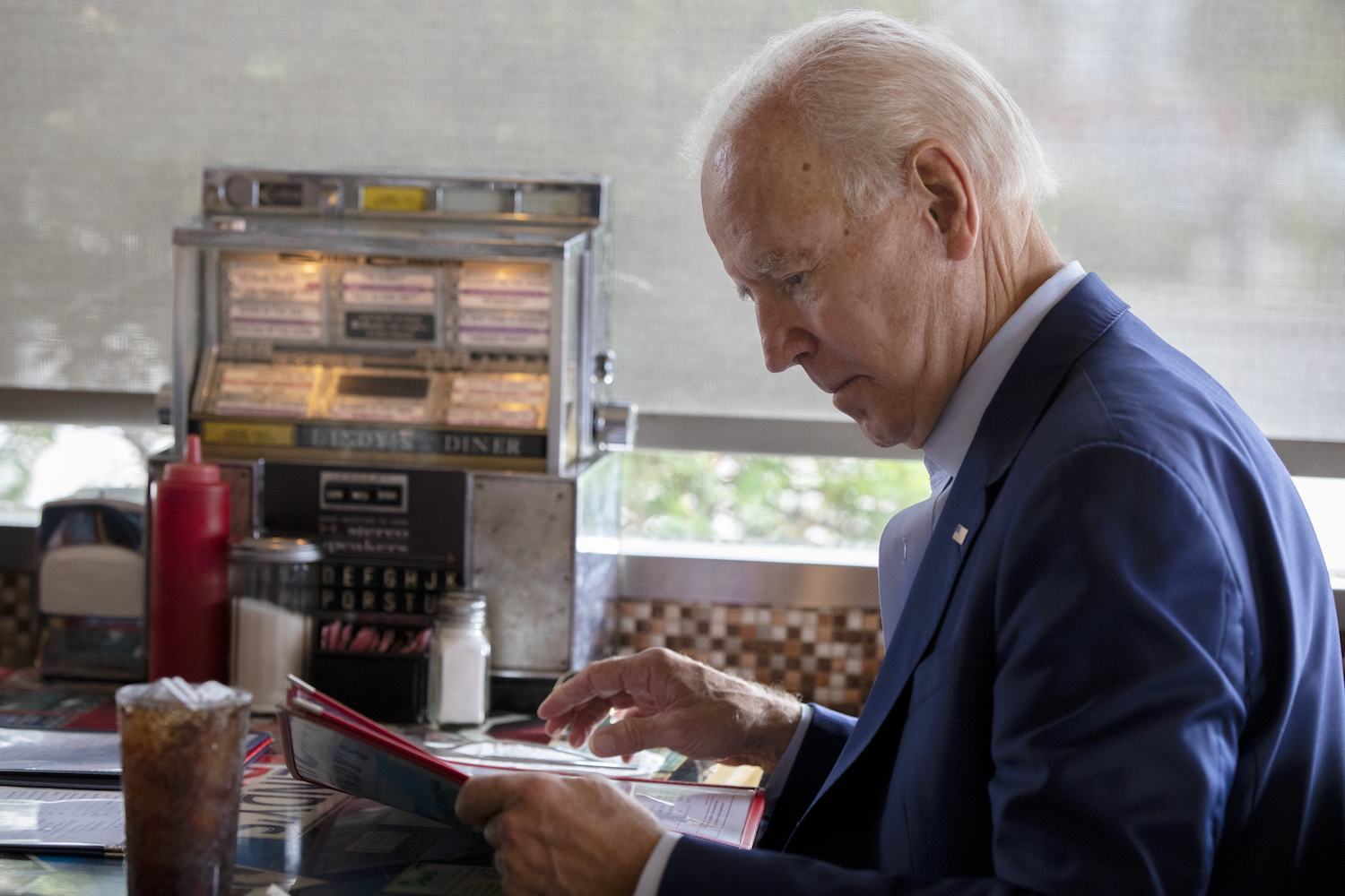 Democratic presidential candidate former Vice President Joe Biden looks at a menu during a campaign stop at Lindy's Diner in Keene N.H., Saturday, Aug. 24, 2019. October 2020