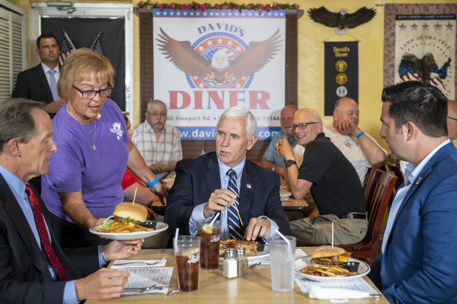 Sen. Pat Toomey, left, Vice President Mike Pence, center, and Sean Parnell, right, who is taking on Rep. Conor Lamb in the 17th Congressional District, are served lunch by waitress Denise, Friday, June 12, 2020, at David's Diner in Springdale, Pa. Pence's visit is the first stop part of the 