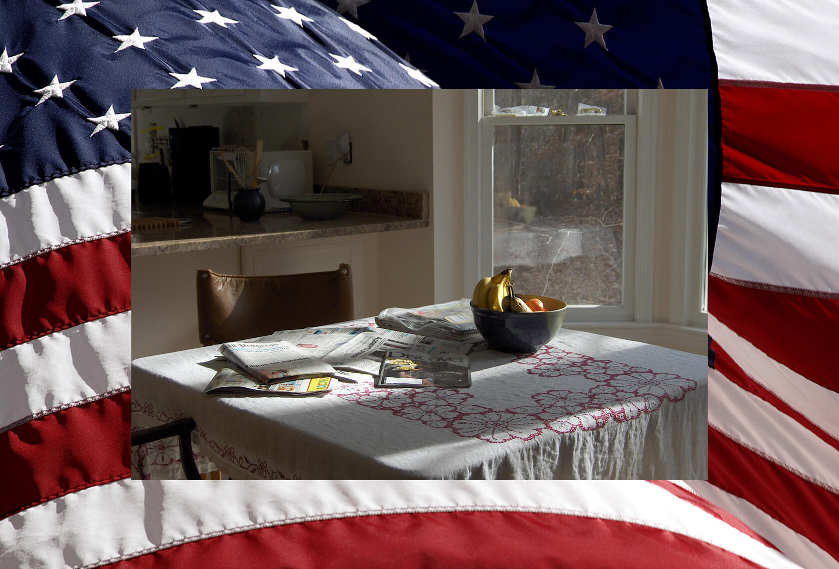 A kitchen table with newspapers and fruit bowl layers over the American flag. November 2020