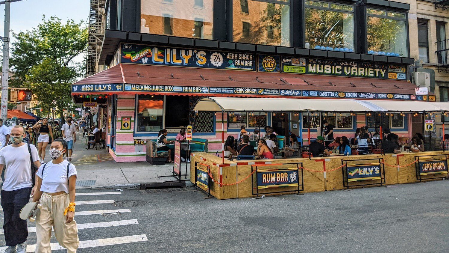 Outdoor dining and passerby at Miss Lily's in Lower Manhattan. Sidewalk space is suddenly in even shorter supply thanks to the Covid-19 pandemic. November 2020