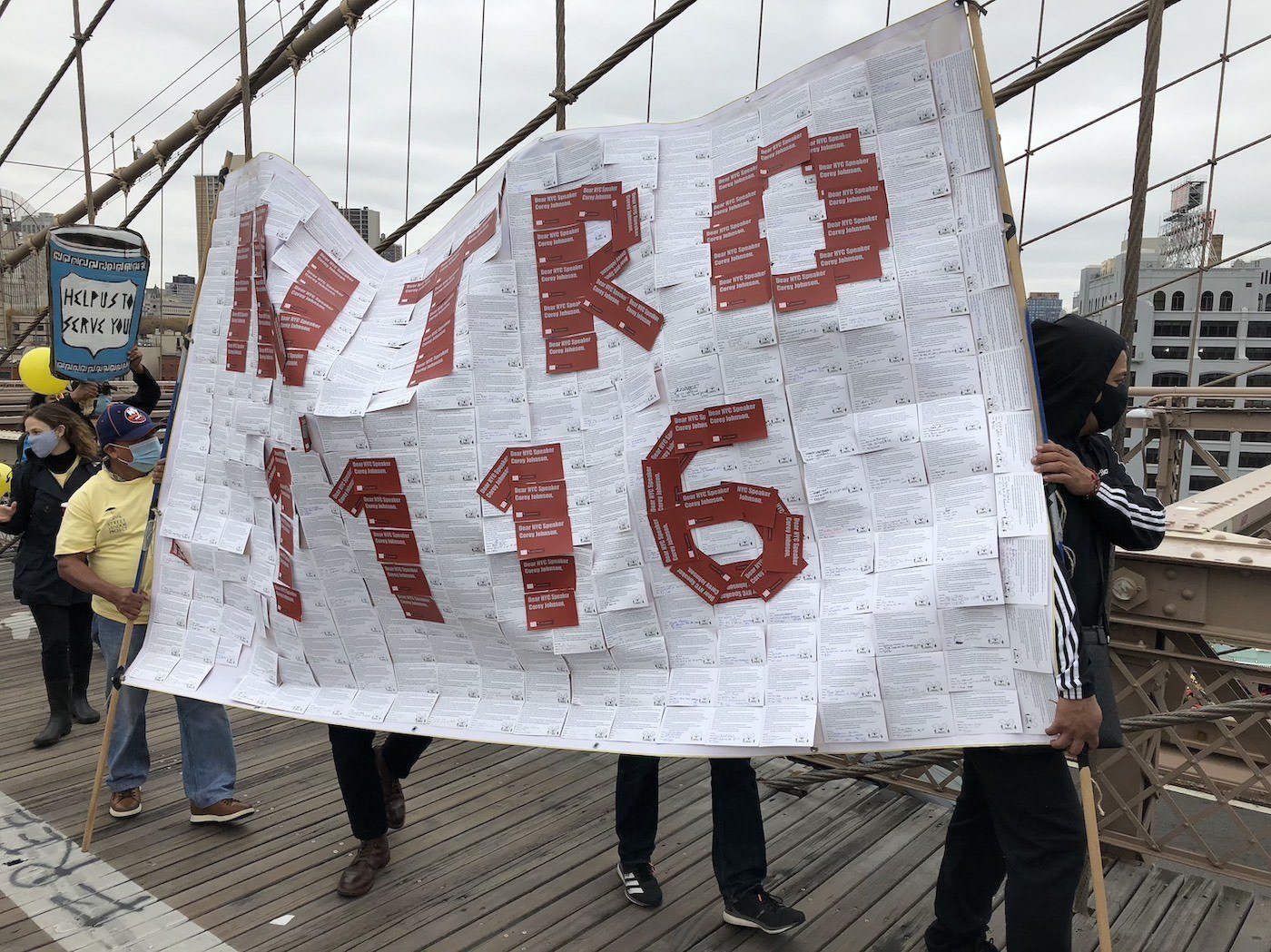 Organizers carry Intro 1116 sign across the Brooklyn Bridge. November 2020