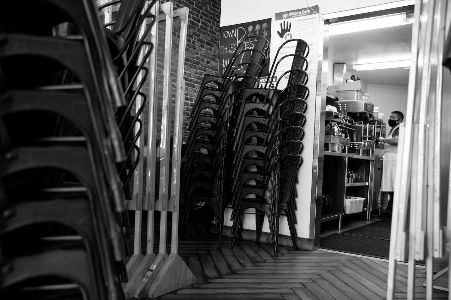Stacked chairs inside Millie's Cafe. December 2020