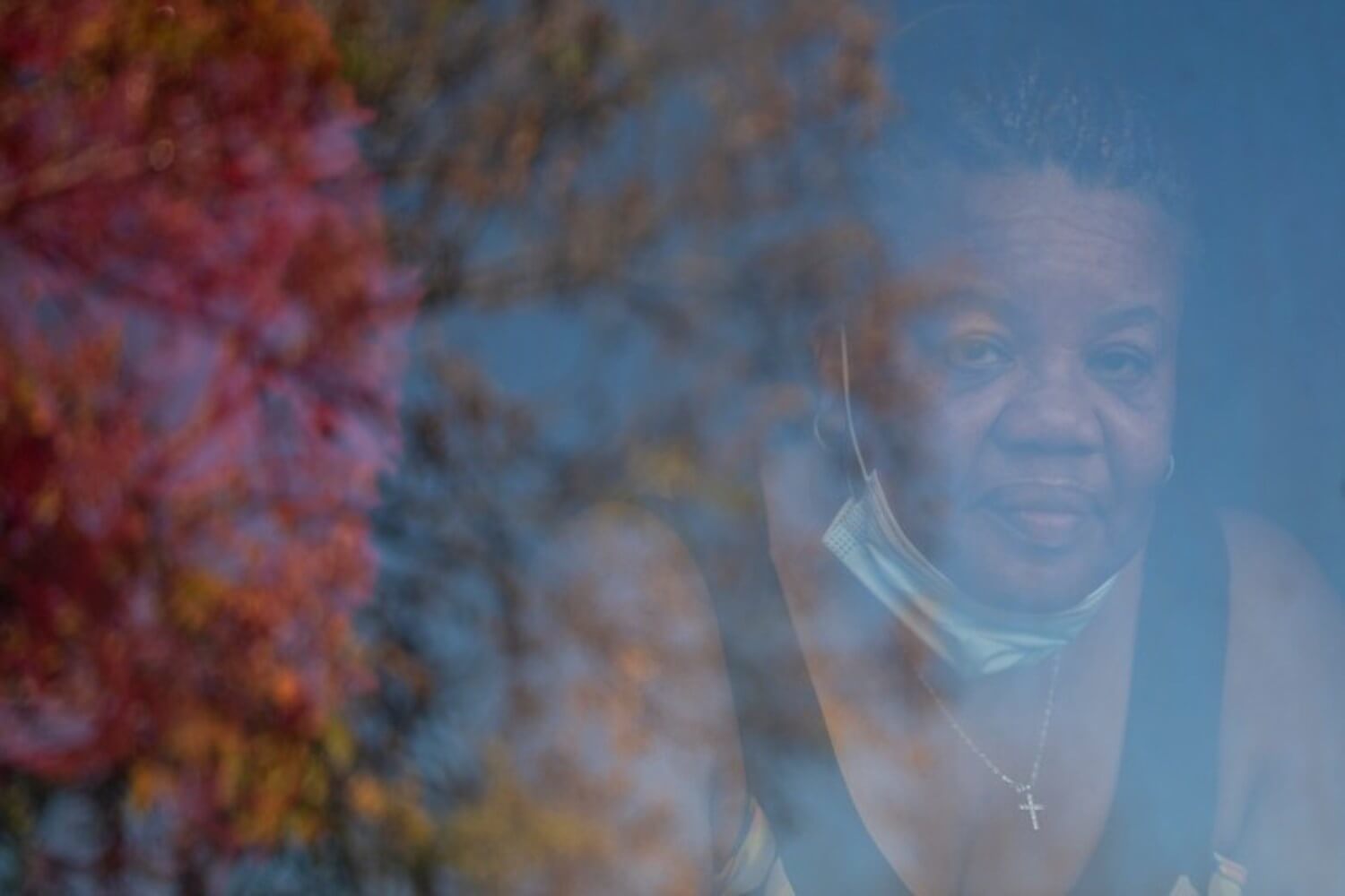 Deborah Bell-Holt looks out the window of her house in Jefferson Park near Downtown Los Angeles on Jan. 21, 2021.