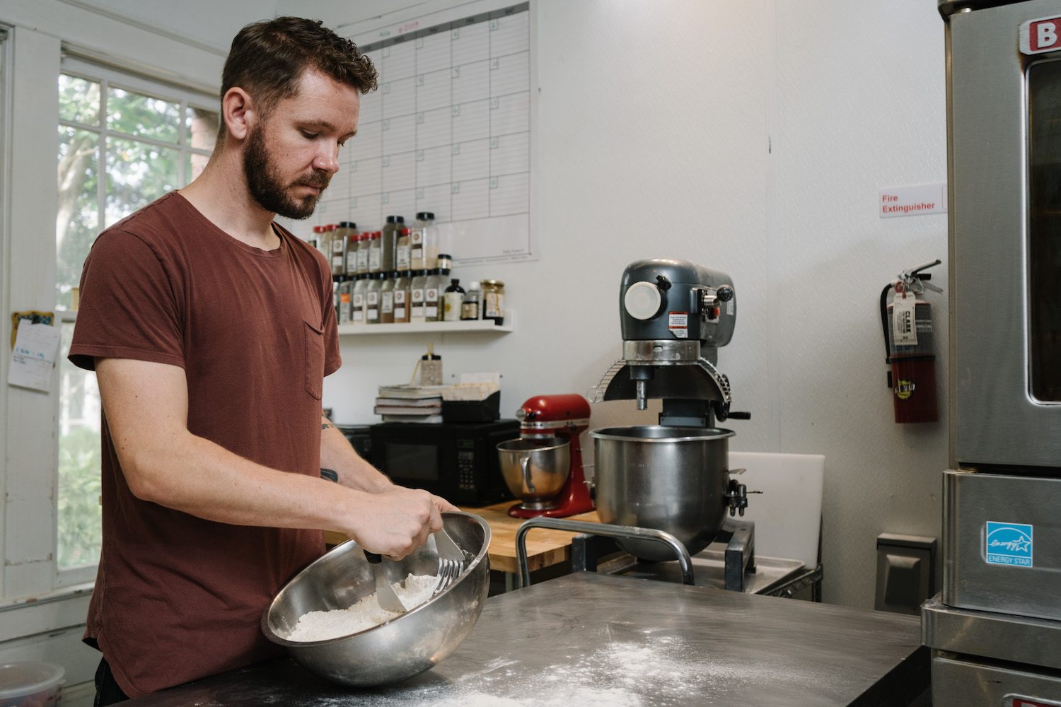 Justin Burke prepares flour in his kitchen. January 2021