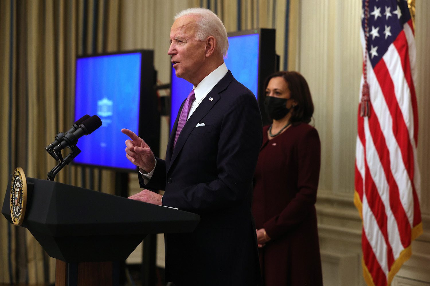 WASHINGTON, DC - JANUARY 21: U.S. President Joe Biden speaks as Vice President Kamala Harris looks on during an event in the State Dining Room of the White House January 21, 2021 in Washington, DC. President Biden delivered remarks on his administration’s COVID-19 response, and signed executive orders and other presidential actions. (Photo by Alex Wong/Getty Images)