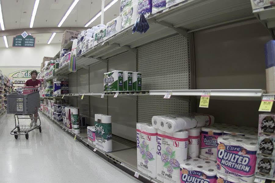 Toilet paper shortages ruffled shoppers' sense of security during the early pandemic. Woman with shopping cart walks down the toilet paper aisle.