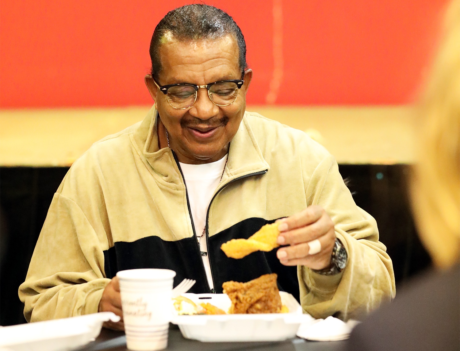 Michael Thompson holds a piece of fried fish during his first meal out of prison. January 28th, 2021.