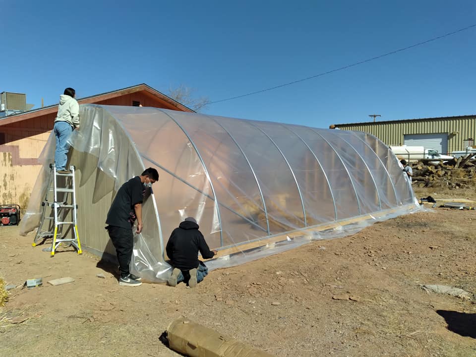 Volunteers build a hoop house at the Leupp Senior Center on the Navajo Nation. February 2021