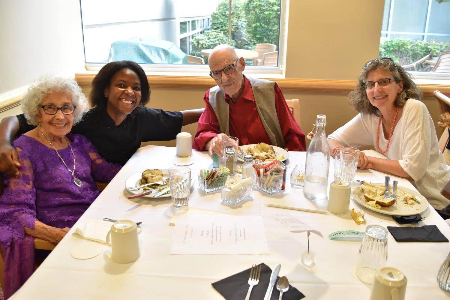 Residents at the Ballard Landmark, an assisted living facility in Seattle sit together for dinner before Covid. March 2021