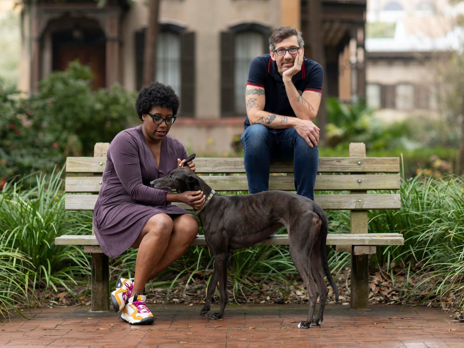 Portrait photo of John O. Morisano and Mashama Bailey with greyhound dog. March 2021