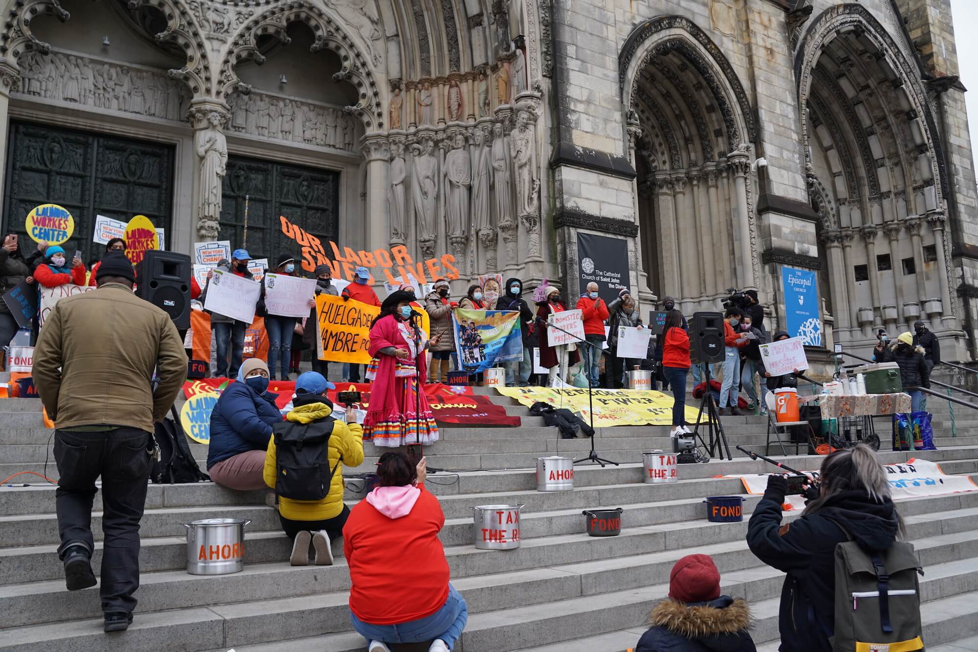 Protestors stand with posters and signs in Manhattan's Morningside Heights outside of the Cathedral Church of St. John the Divine. March 16, 2021