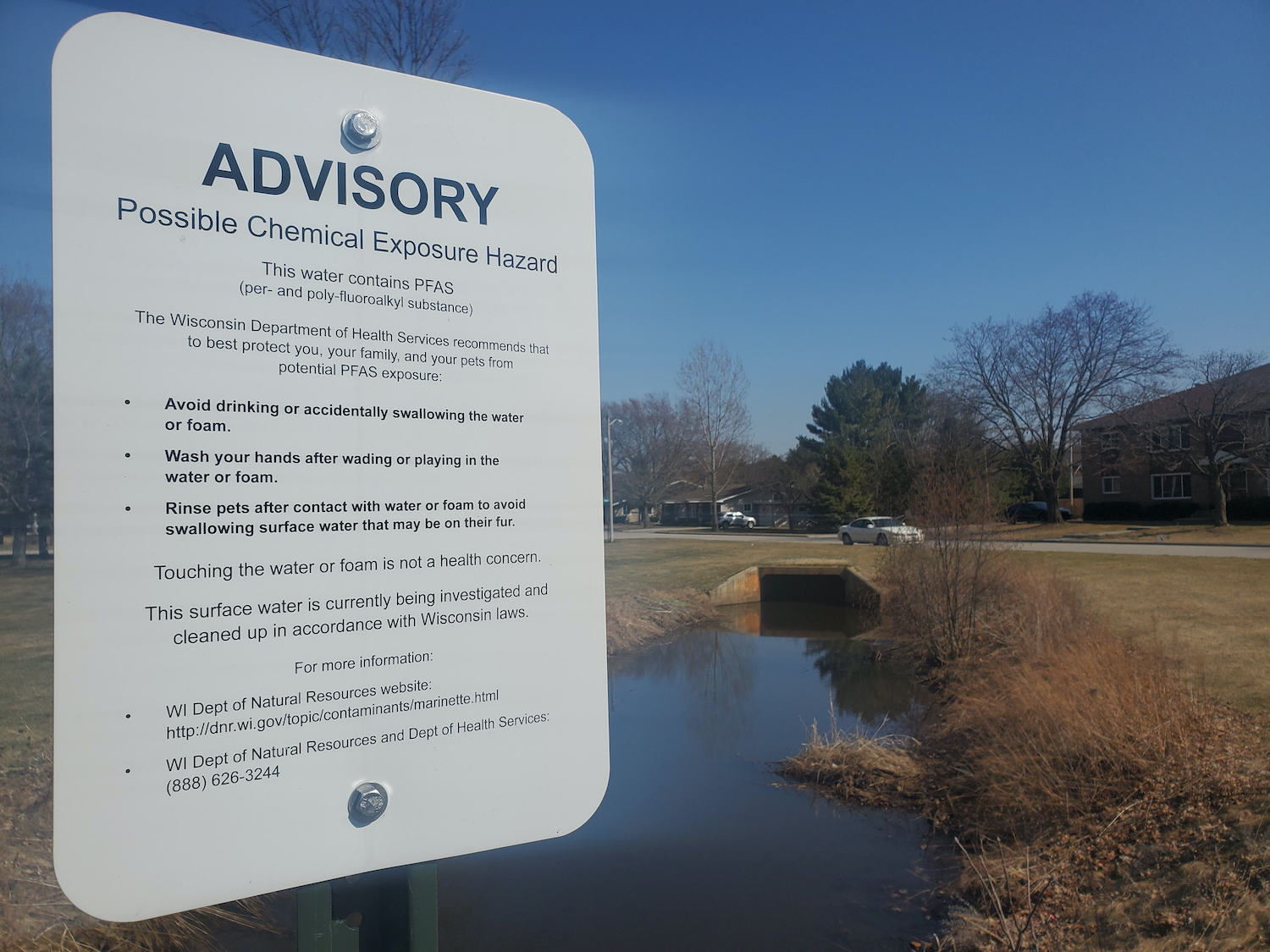 Signs posted along a ditch running through a Southern Marinette, WI neighborhood warn against exposure to the forever chemicals known as PFAS on Monday, April 5, 2021.