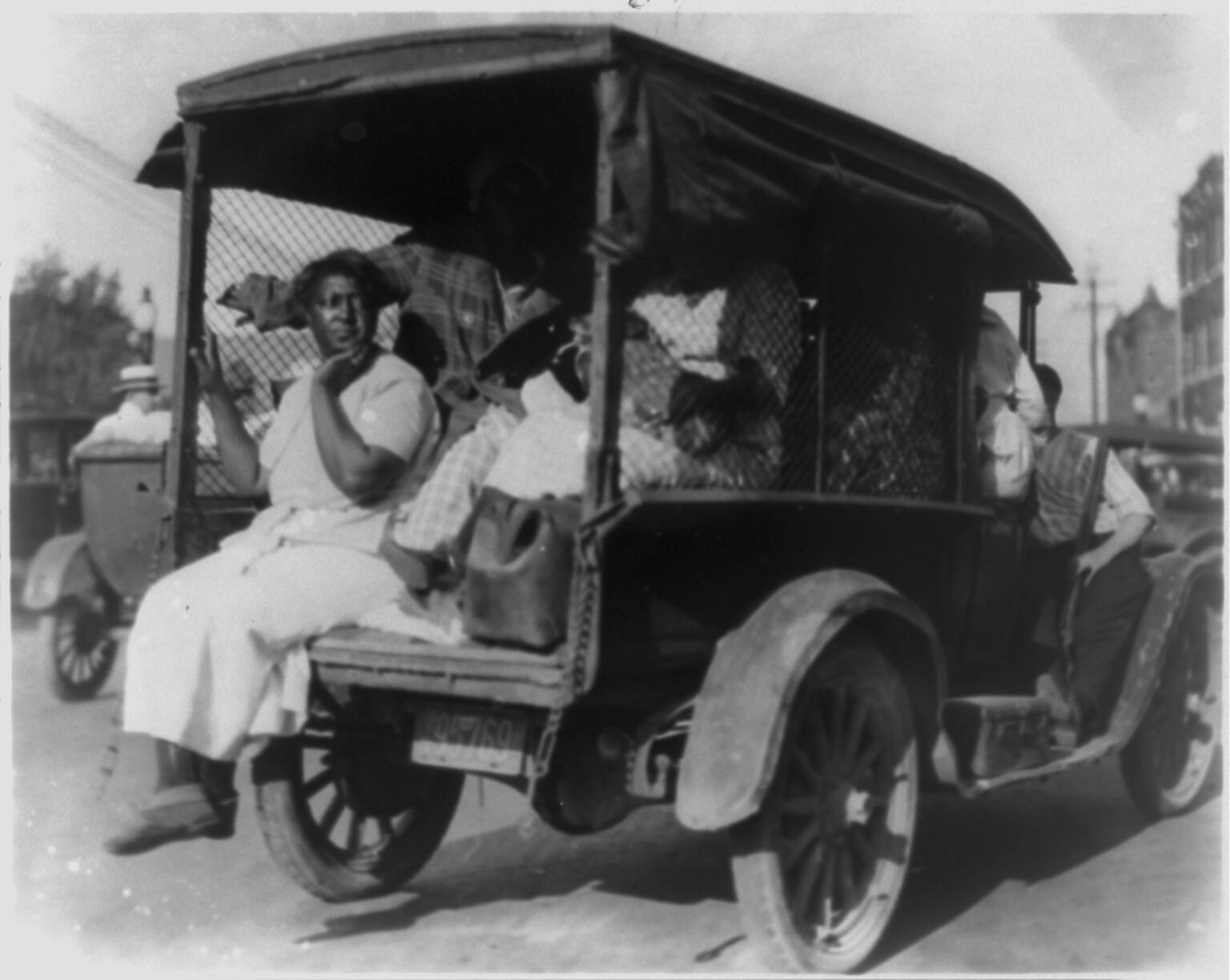 An African American woman sits in the back of a truck fleeing during the Tulsa Race Riots in 1921. May 2021