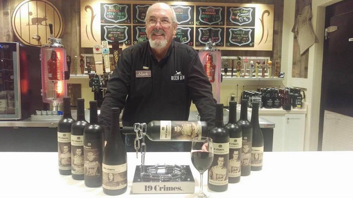 Mark stands in front of 19 Crimes wine at the Beer Den. NC