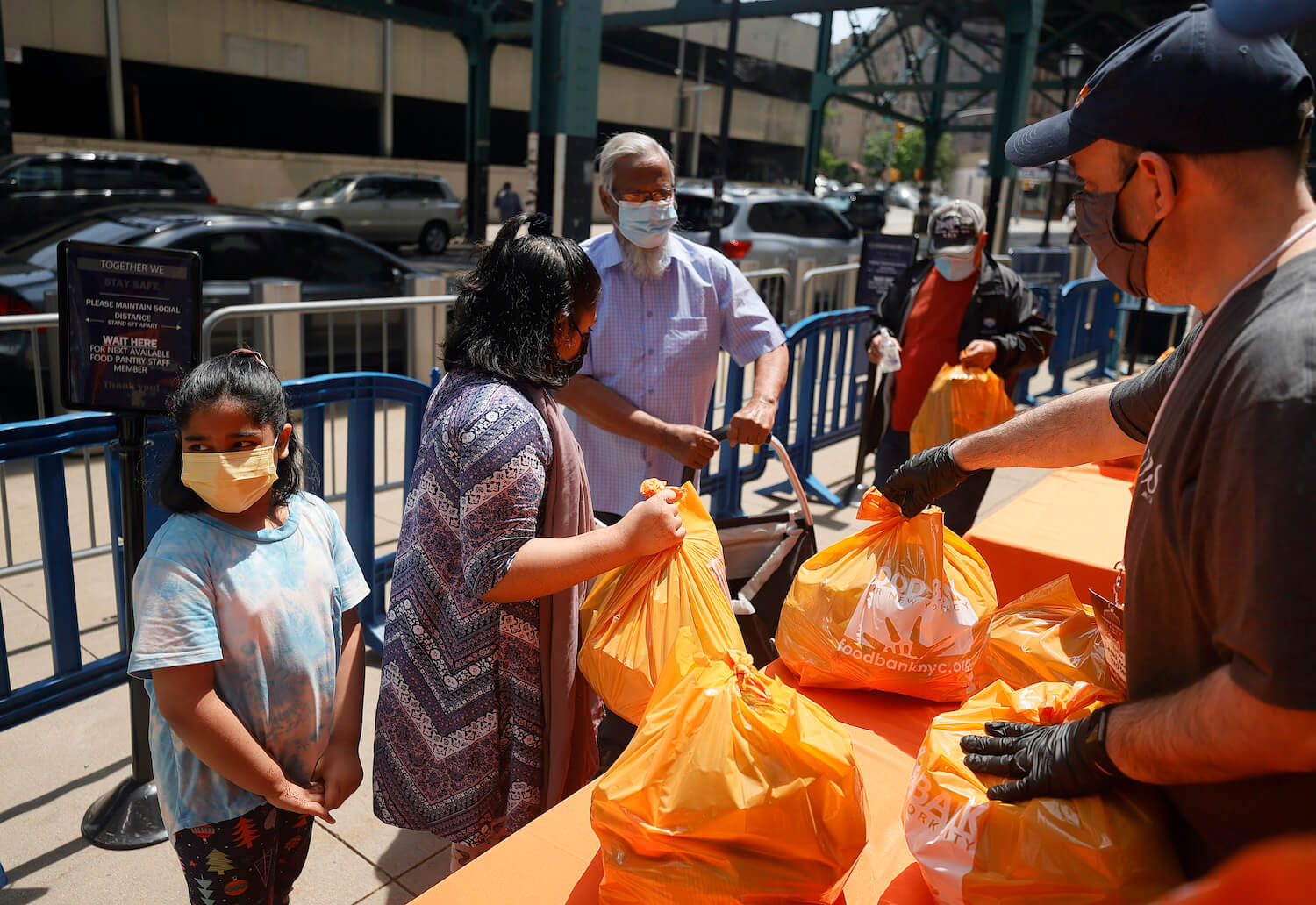 A local family receives food items as Food Bank For New York City teams up with the New York Yankees to kick-off monthly food distribution for New Yorkers in need at Yankee Stadium on May 20, 2021. June 2021