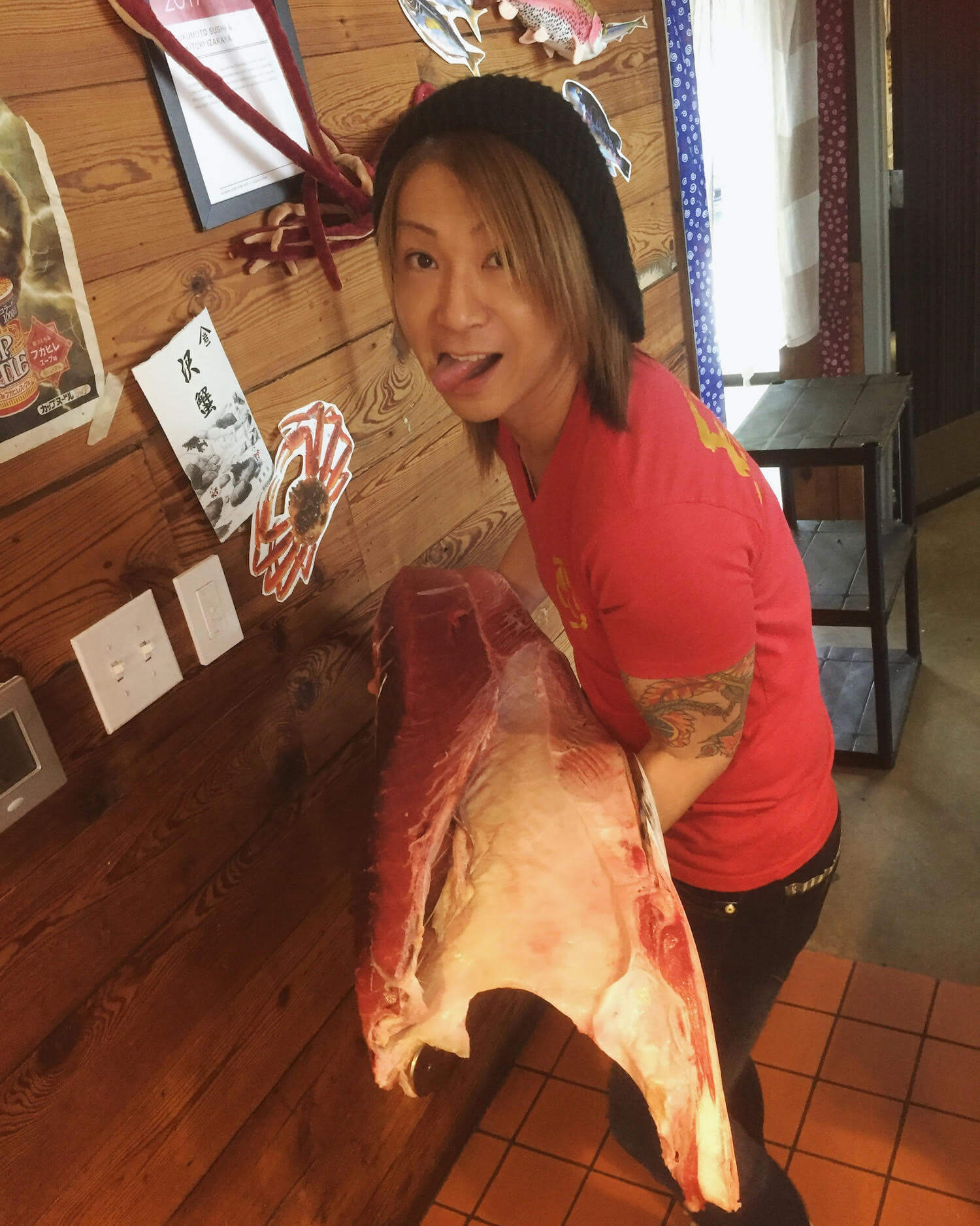 A photo of Kazu Fukumoto holding a cut of fish. June 2021