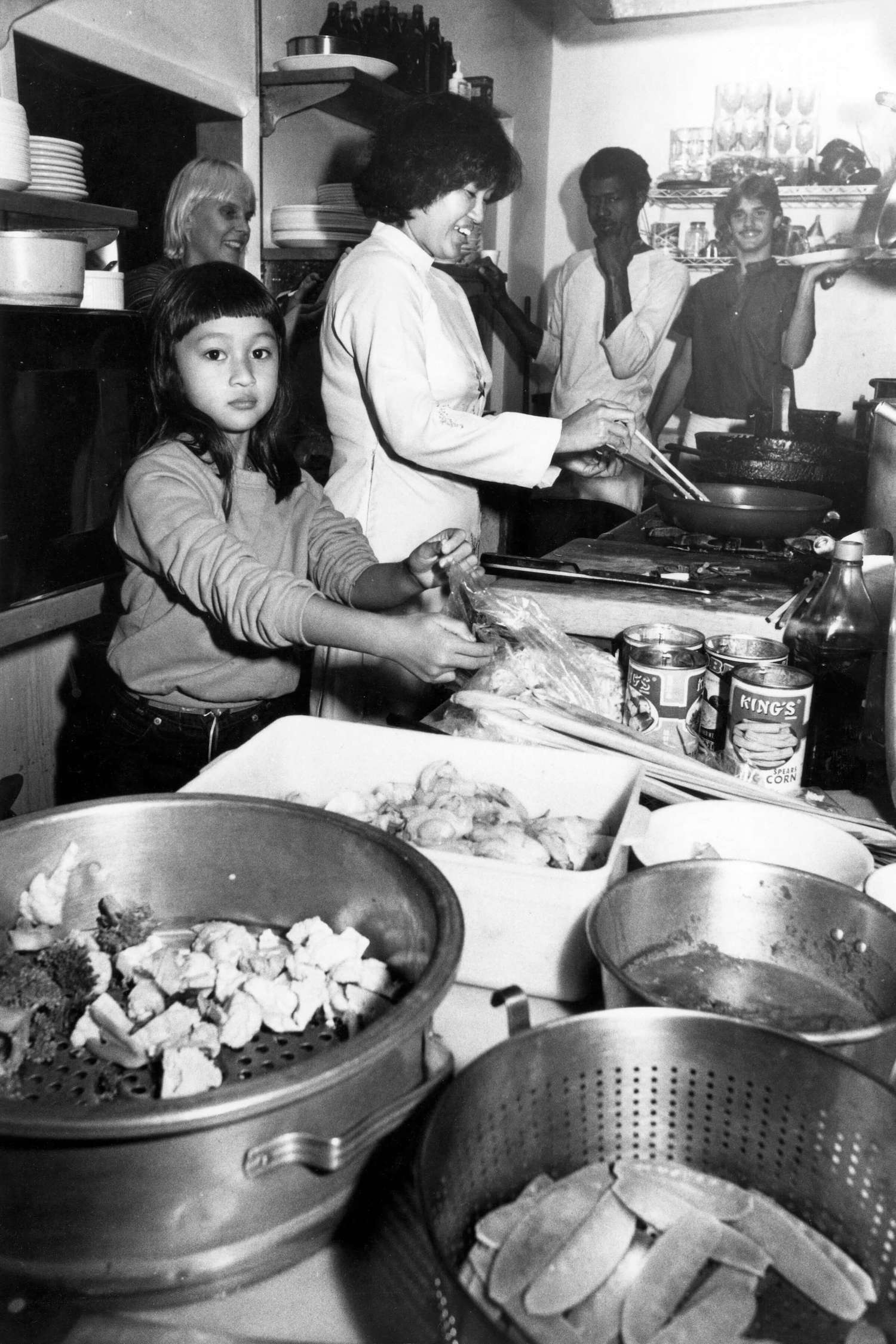 Phuong Lien (now Lyn), Kathy Manning, and Tung Nguyen cooking at Hy Vong, 1982. June 2021